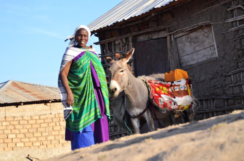 Sabina with a donkey in front of her house